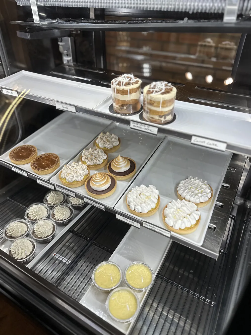 Tarts, tiramisu, cakes and creme brulee in Mokaya's pastry case.
